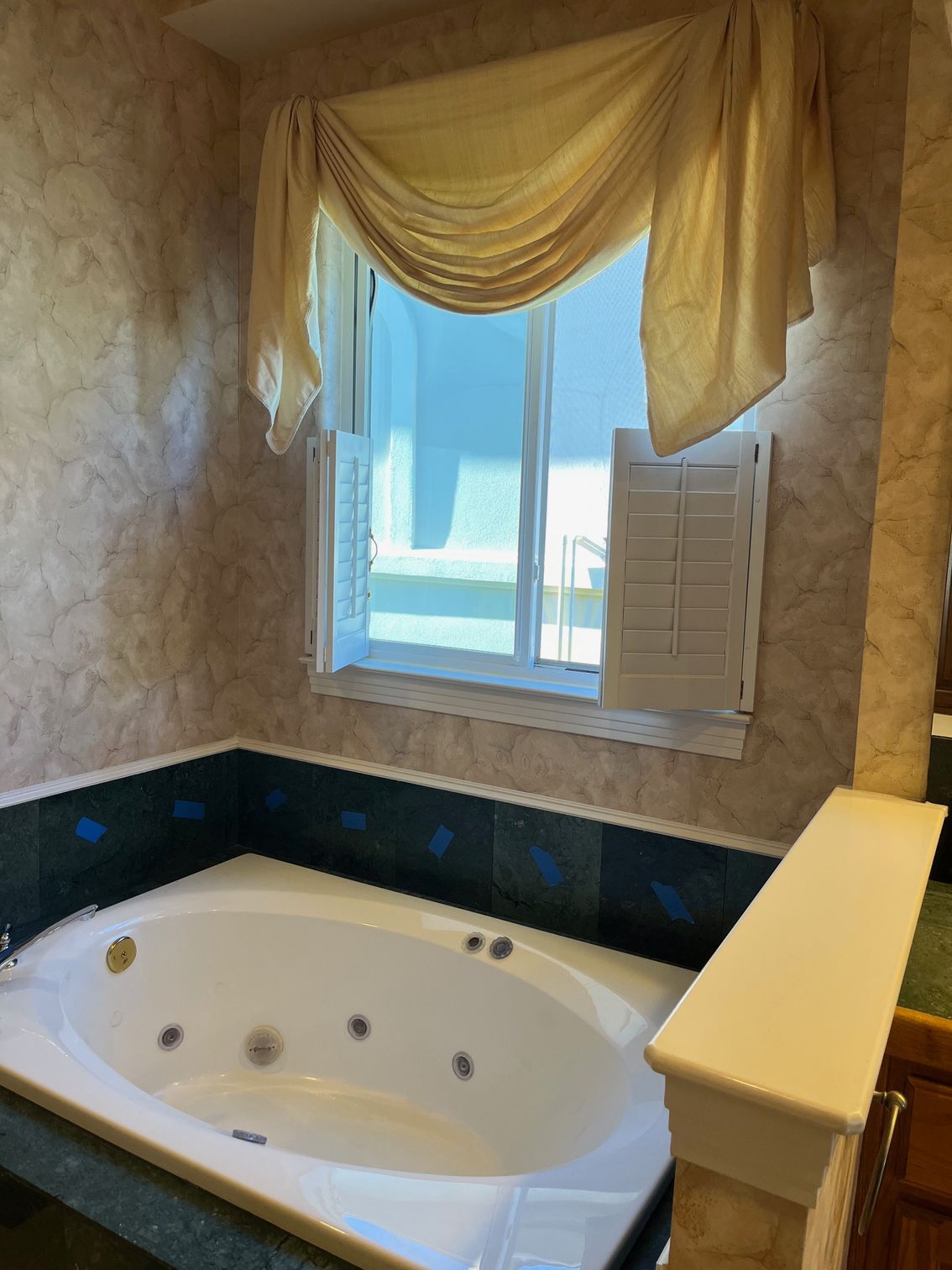 A bathroom with a jacuzzi tub and a window