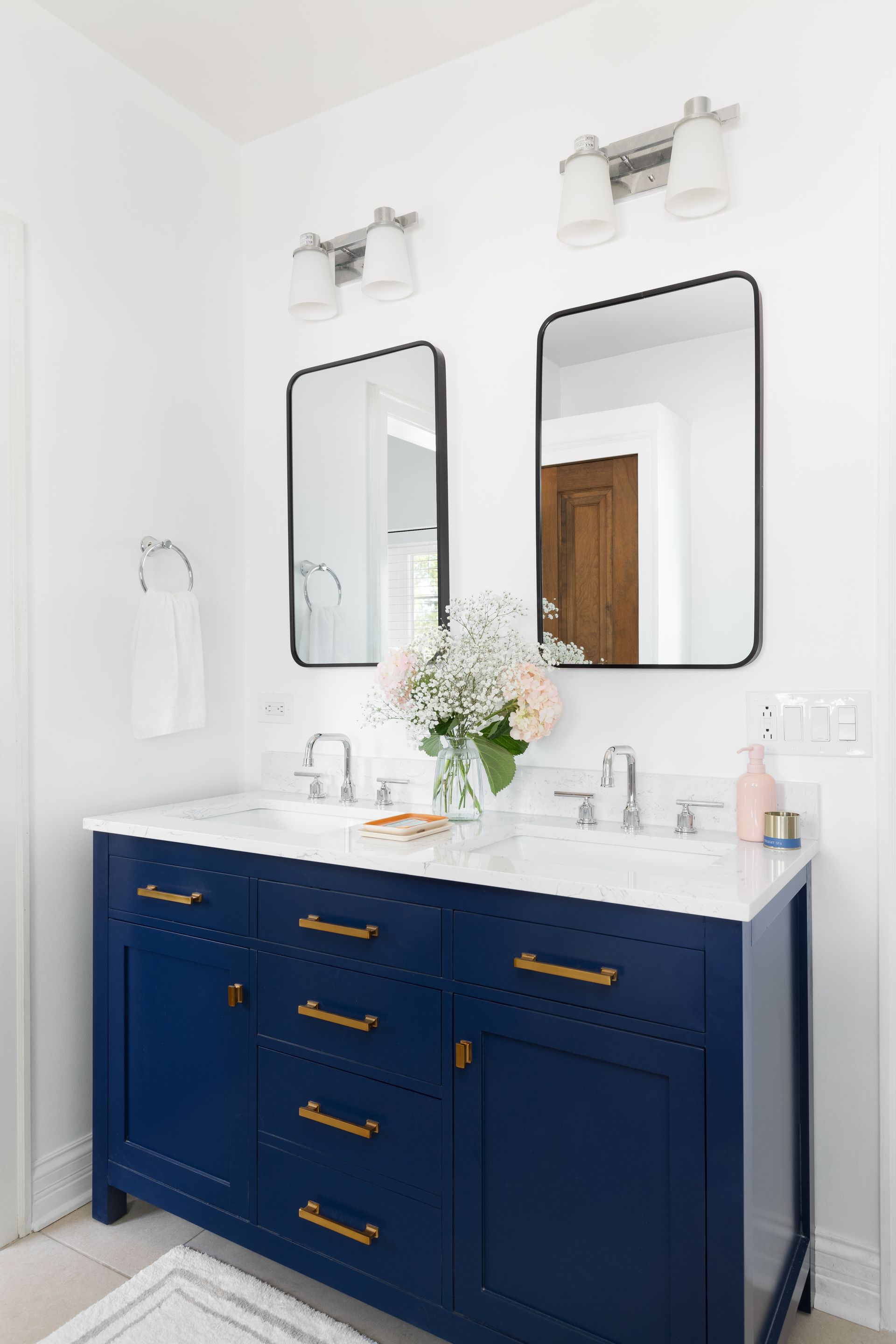 a bathroom with blue cabinets and two sinks