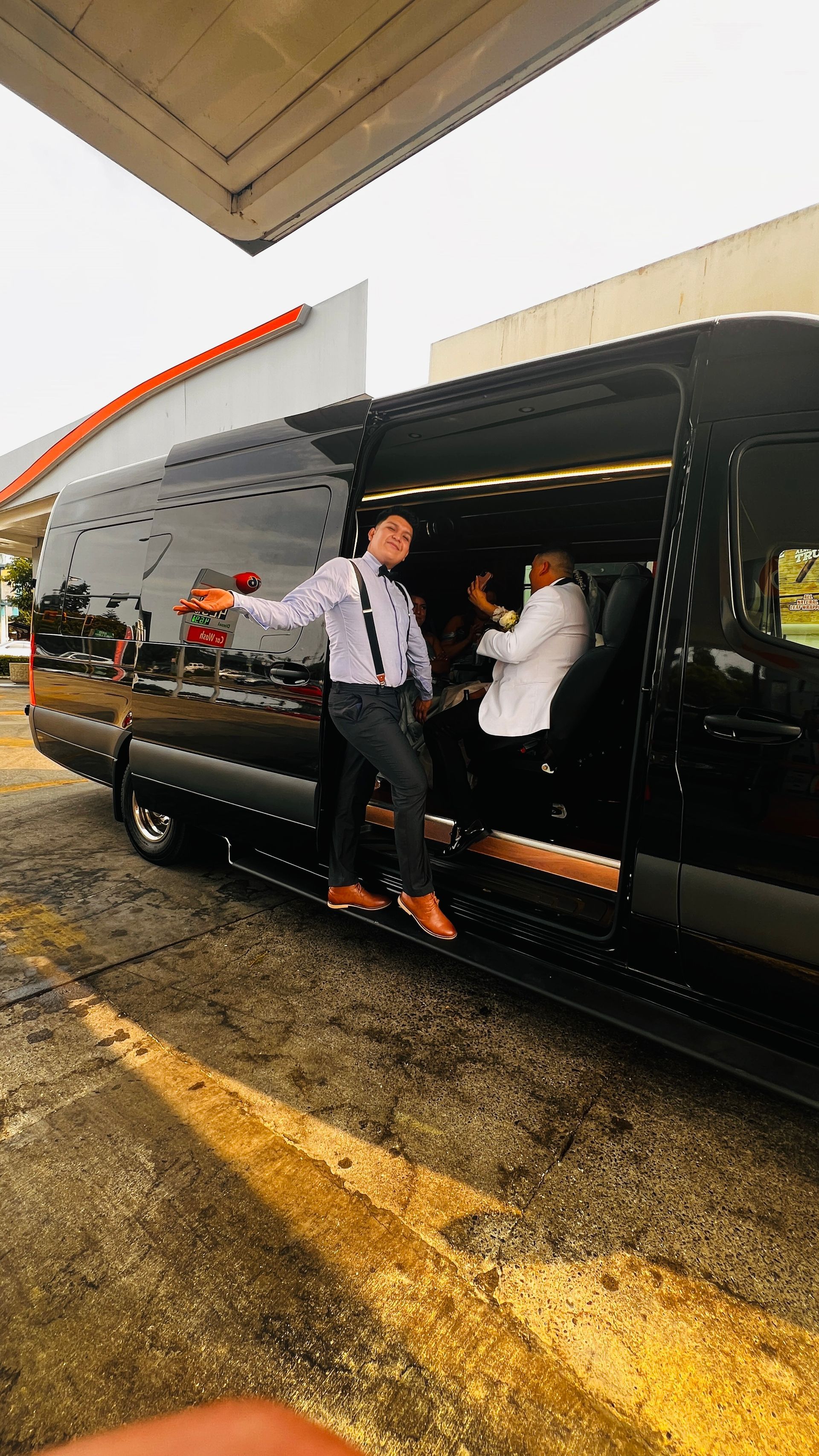 Silver vintage Bentley car with chrome details parked on a street.