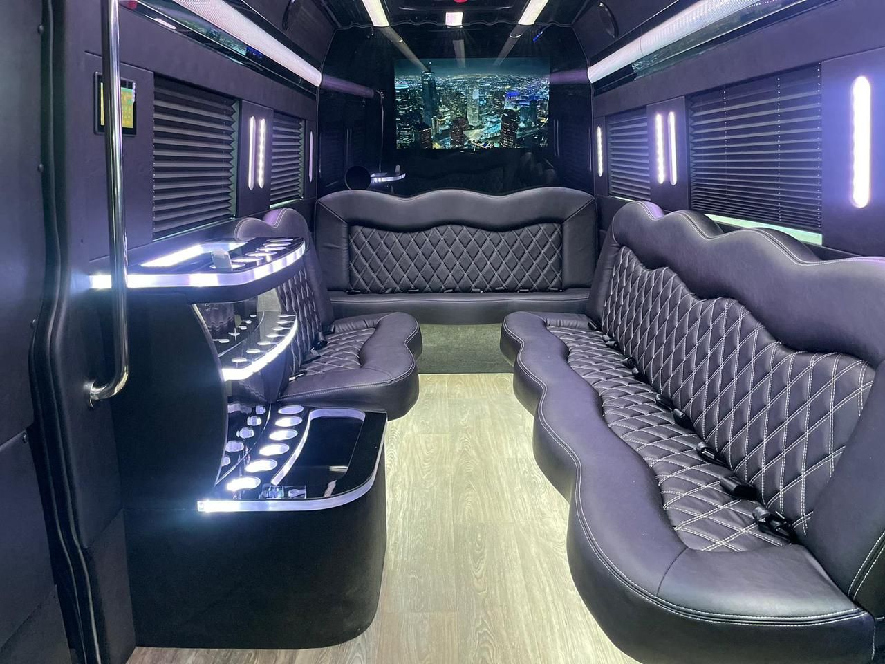 White car interior with cup holders, a knob, and leather seats.