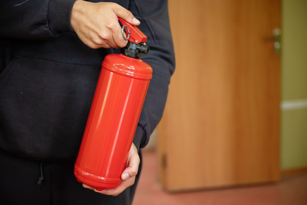 man holding fire extinguisher