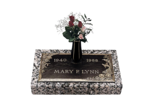 Gravestone marked Mary F. Lynn, 1940–1988, with a flower arrangement on top.