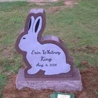 Rabbit-shaped gravestone for Erin Whitney King, with black lettering and date Aug. 8, 2014.