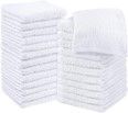 A stack of white towels sitting on top of each other on a table.