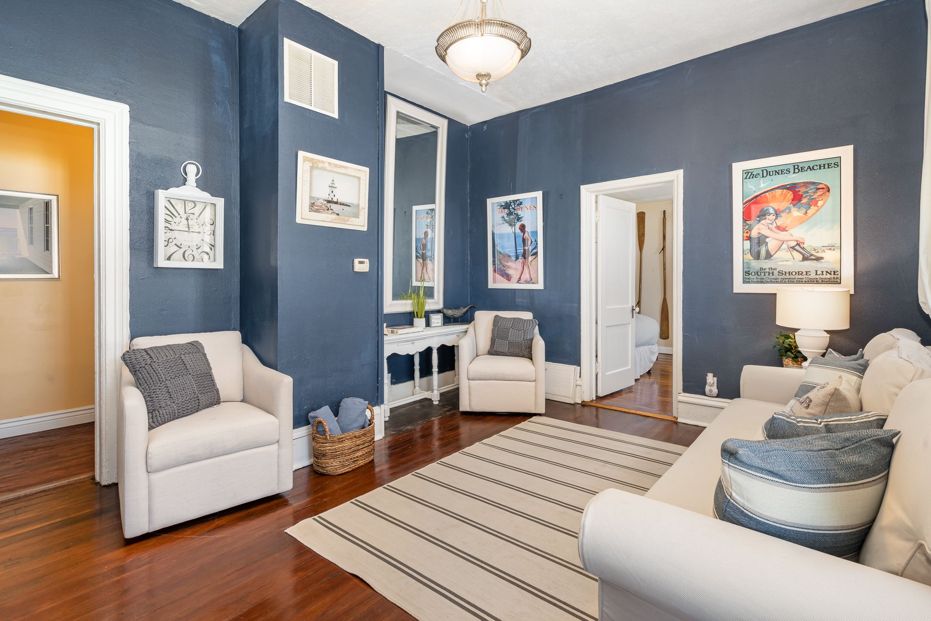 A living room with a couch , chairs , and a rug.