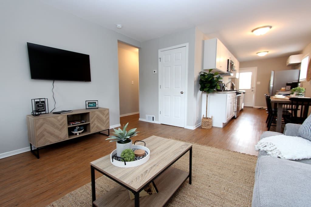 A living room with a coffee table and a flat screen tv