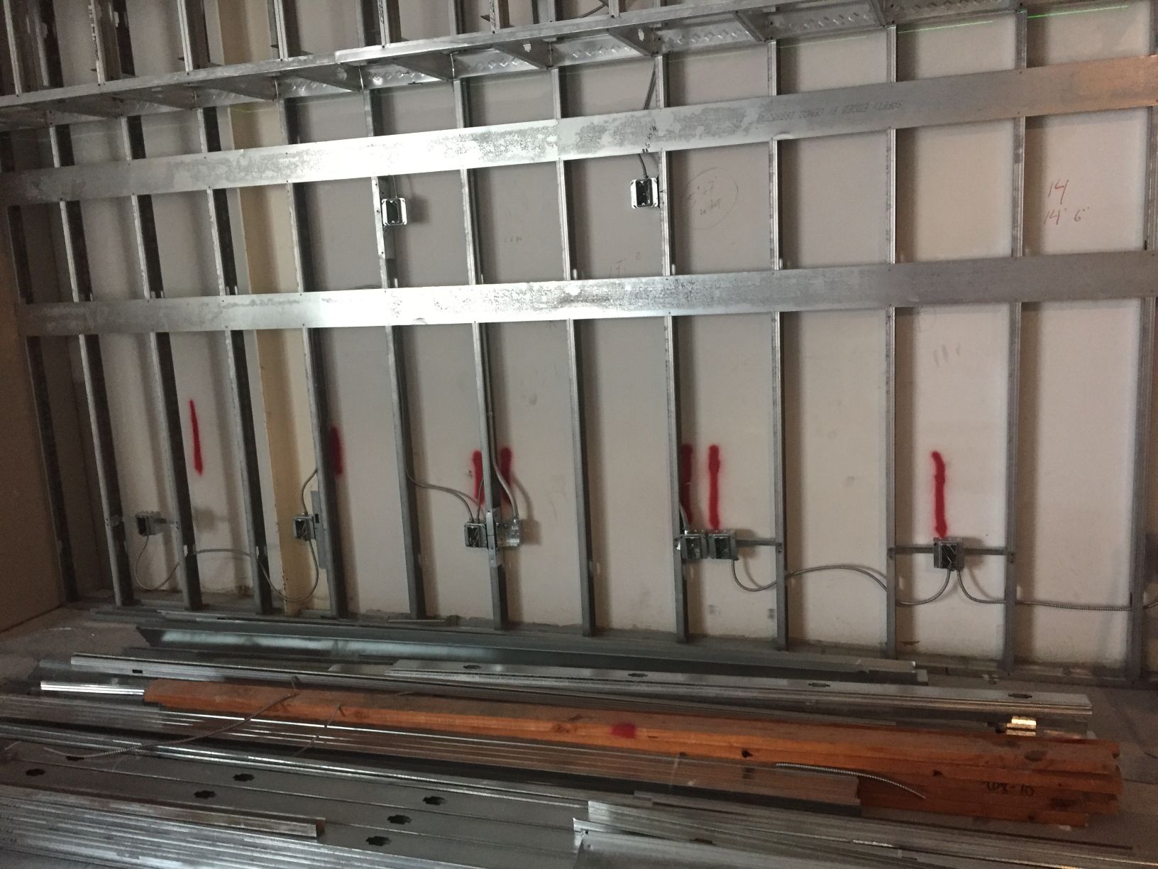 A room with a lot of metal frames on the wall.