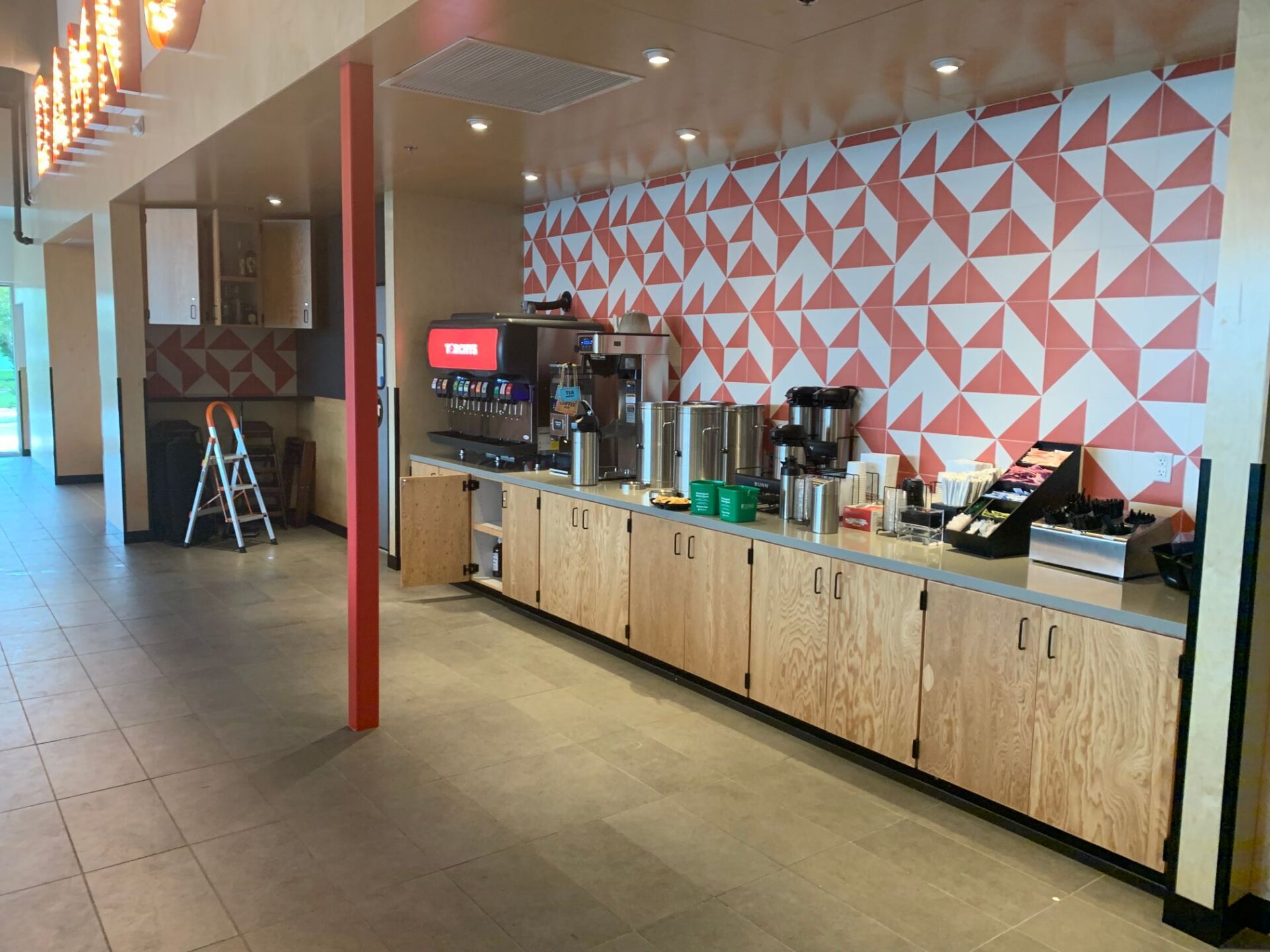 A kitchen with wooden cabinets and a red ladder