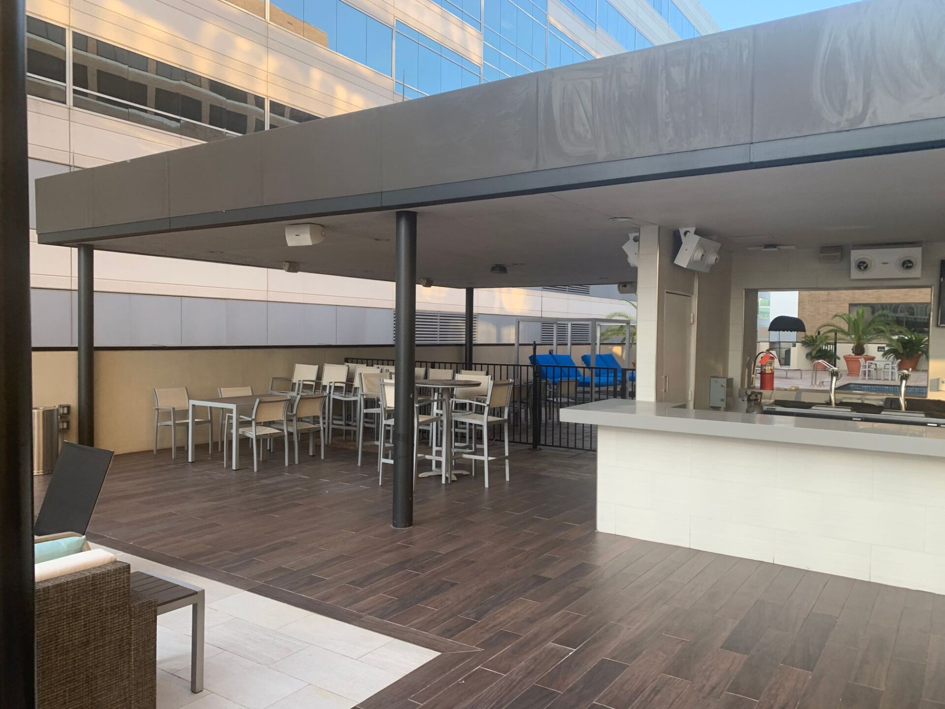 A patio with tables and chairs under a canopy.