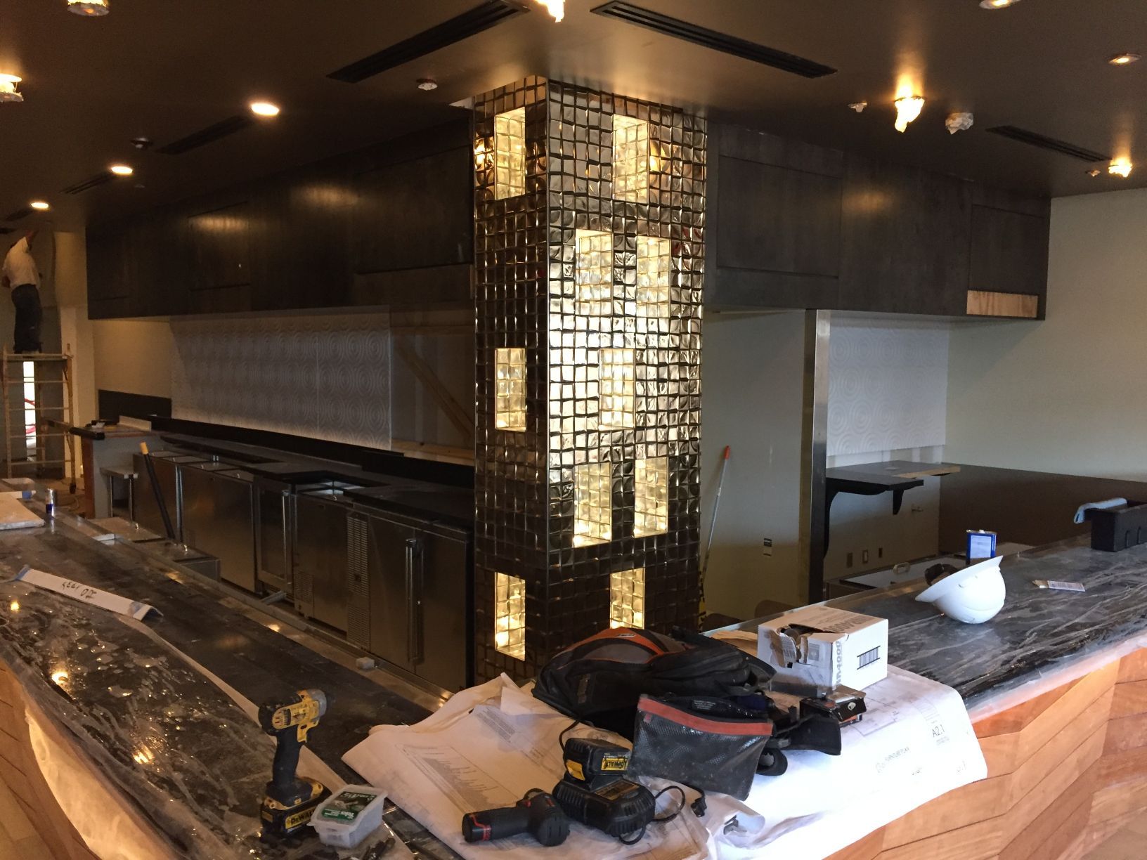 A kitchen is being remodeled and a drill is on the counter