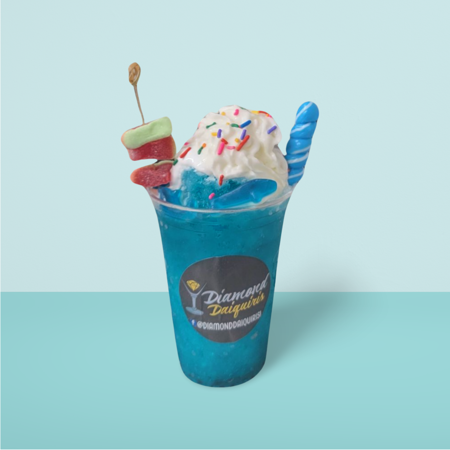 A blue drink with ice cream and sprinkles in a cup that says diamond delight