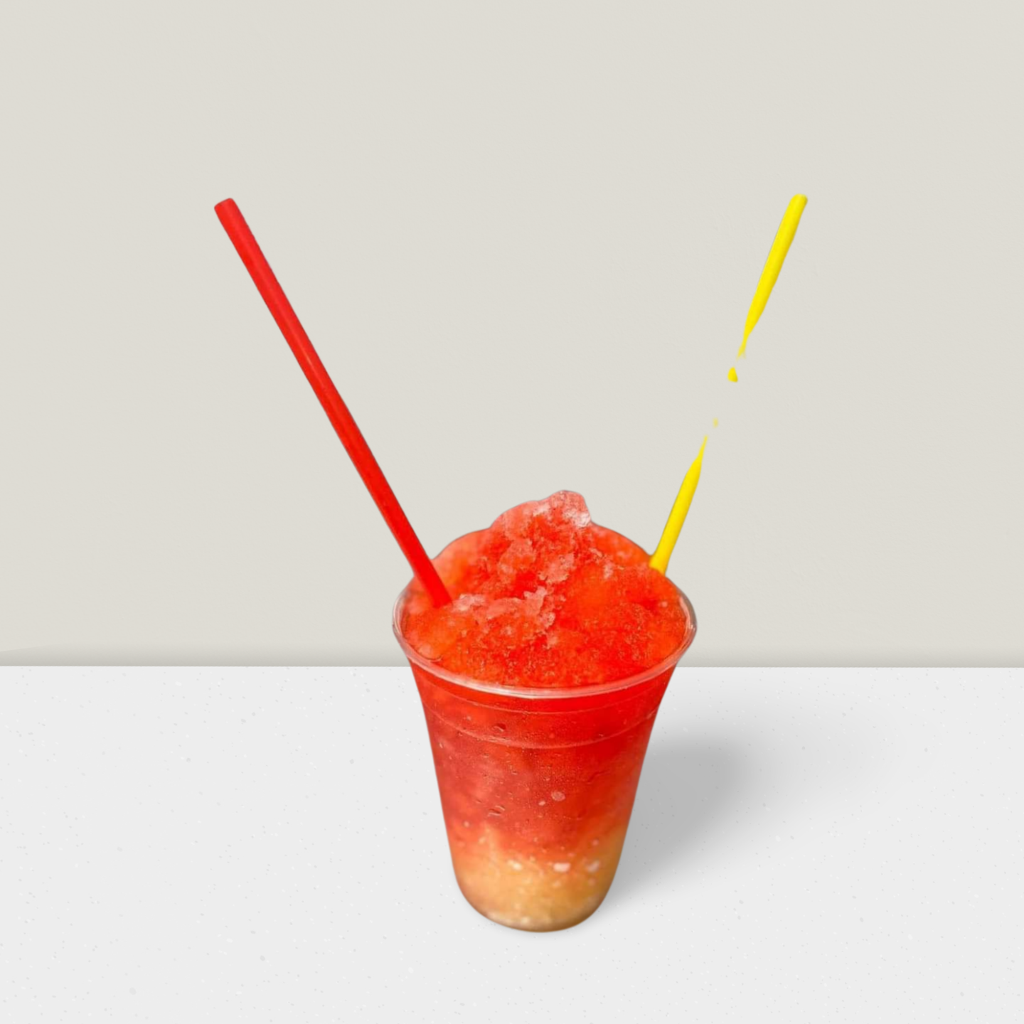 A cup of slush with two straws in it