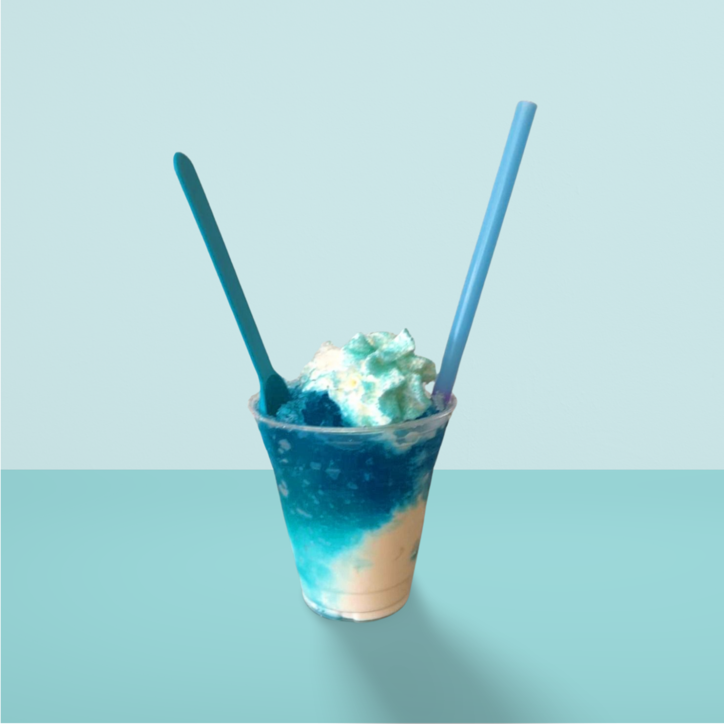 A cup of ice cream with whipped cream and two straws