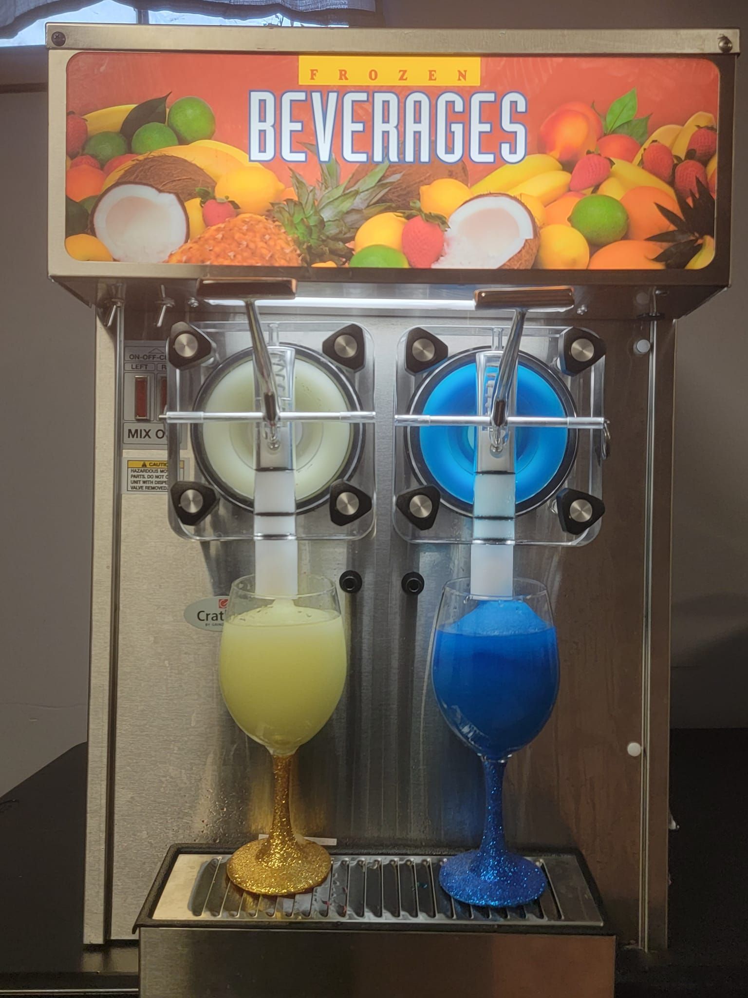 Two drinks are being poured from a machine that says beverages
