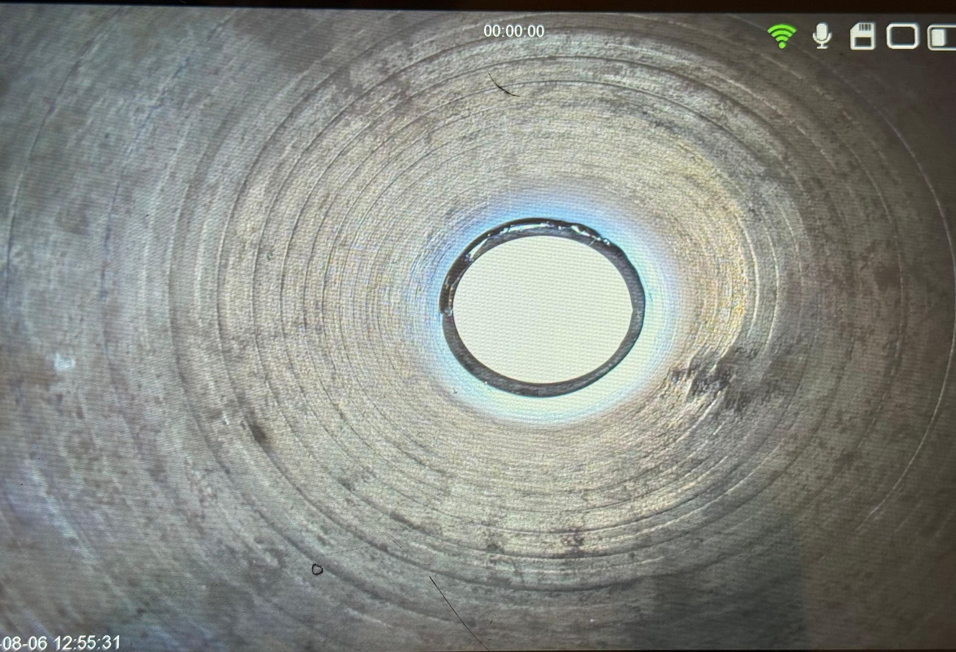 Chimney inspection setup: Camera on a stand displays the interior. 
