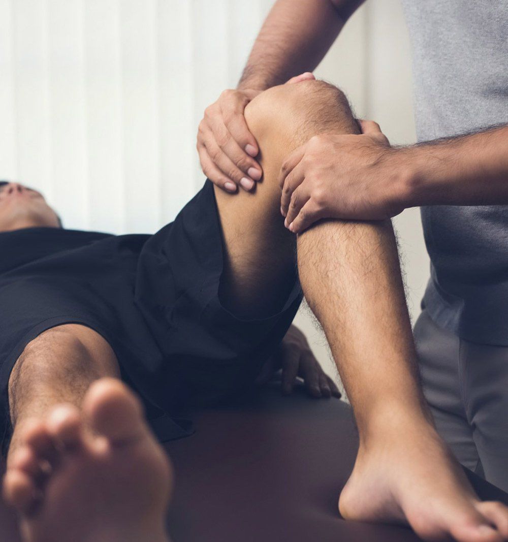 Male Therapist Massaging Knee — Massage in Port Stephens, NSW