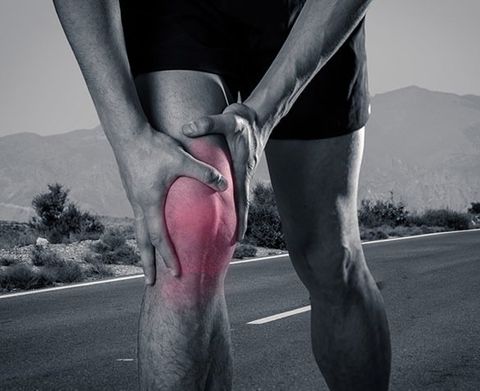 Young Fit Man Holding Knee — Sports Injury Clinic in Port Stephens, NSW
