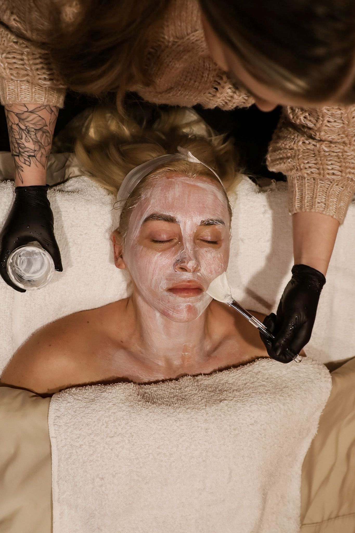 A woman is getting a facial treatment at a spa.