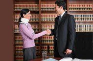 Solicitor shaking hand of woman in a neck brace