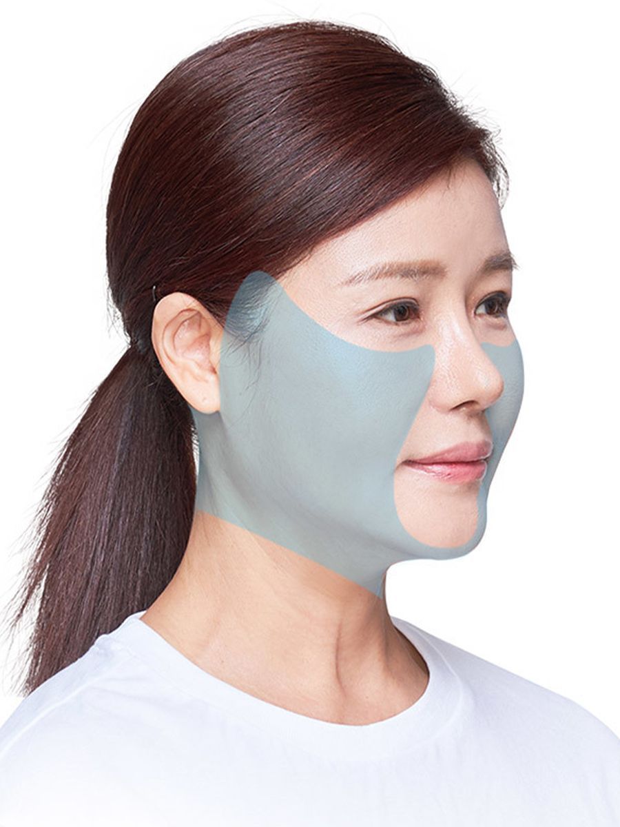 Woman wearing a facial mask, side profile view, highlighting jawline.