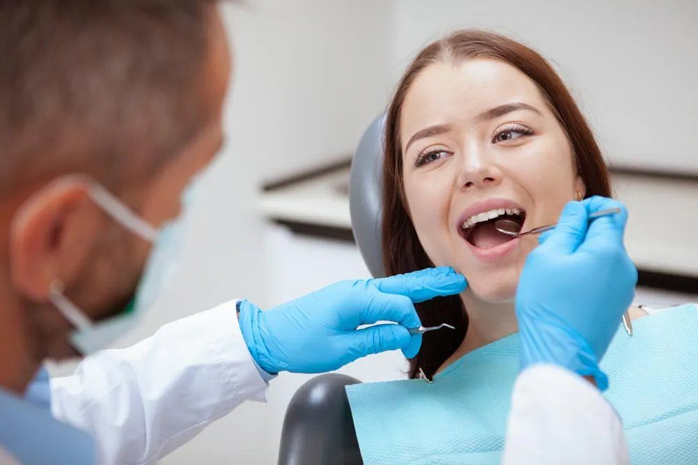 Woman Having Her Teeth Examined by Dentist — Amherst, OH — Gregory Sy, DDS