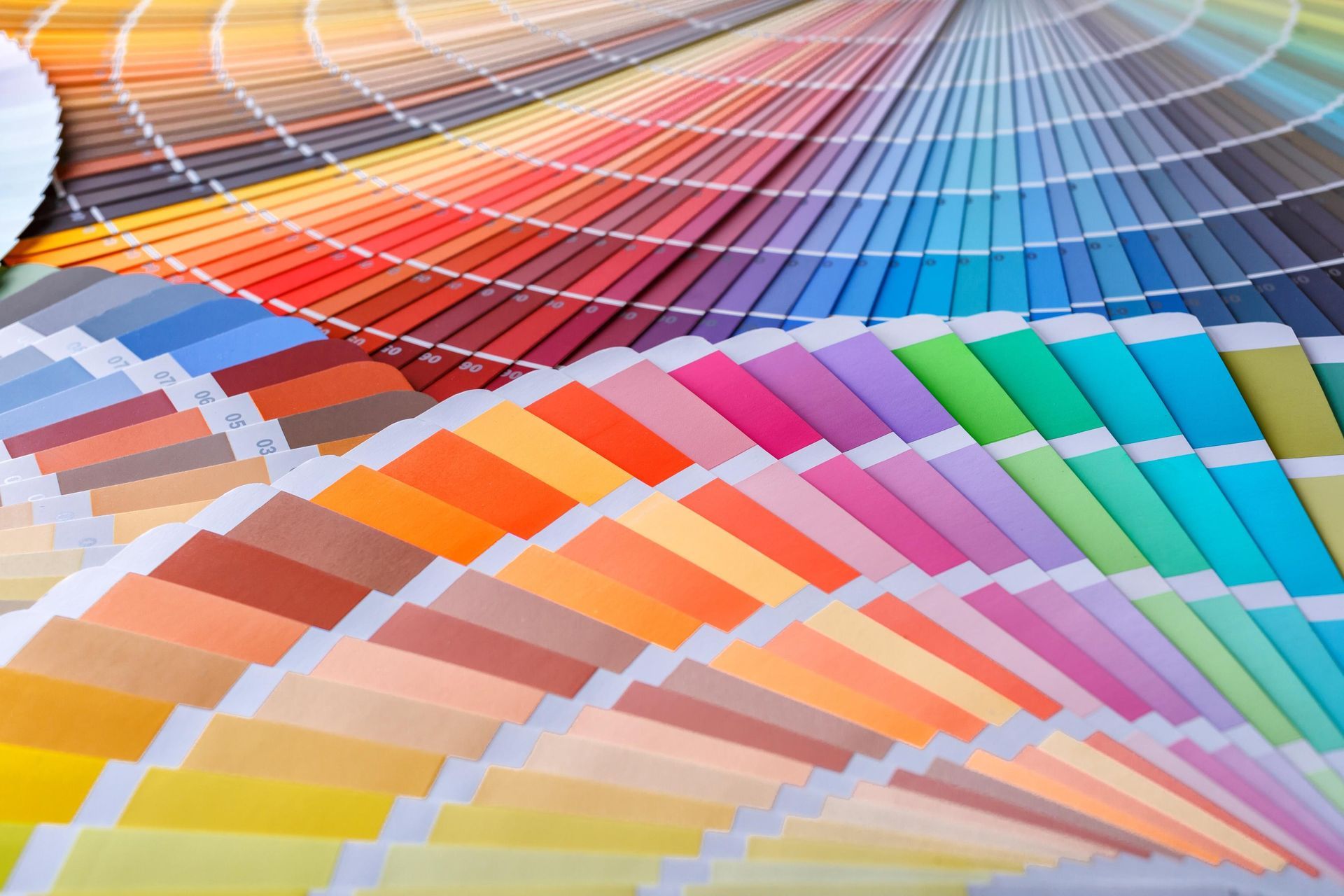 A bunch of different colored papers are laying on a table.