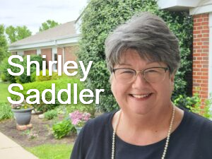 Shirley Saddler, childrens minister, standing in front of Hanfield GMC.