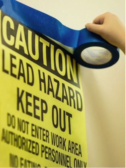 The Caution Sign indicates that there is  Lead Hazard, and to keep out.