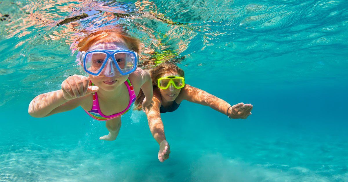 two girls swimming underwater