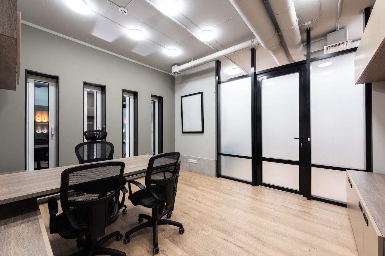 A conference room with a table and chairs in it.