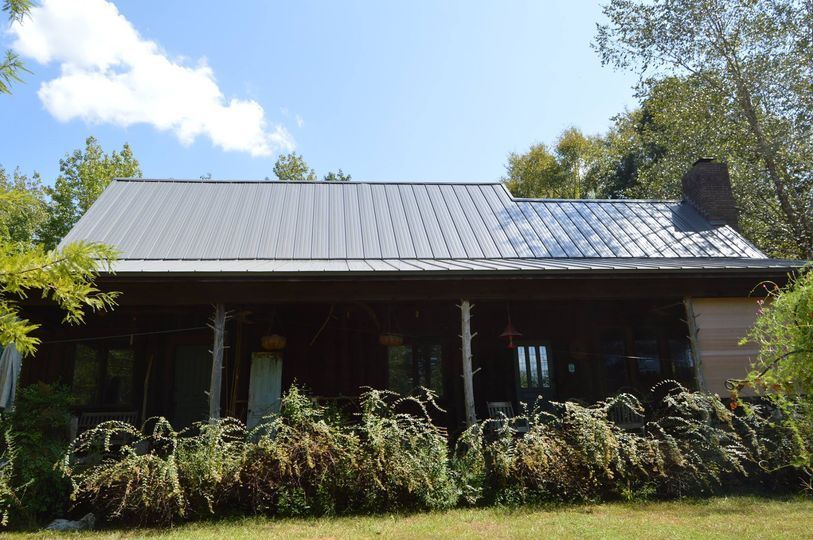 A house with a metal roof and a porch