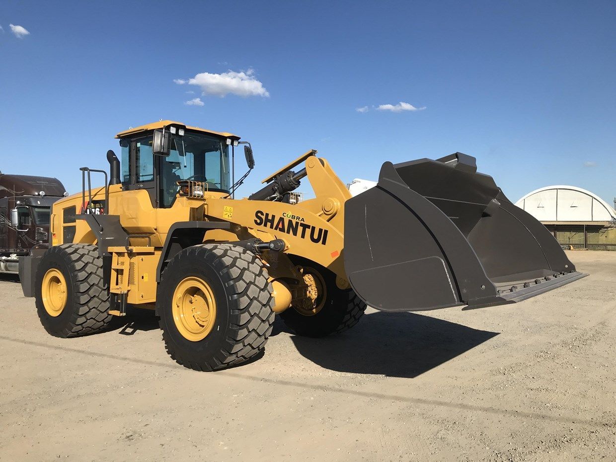 Yellow Shantui wheel loader with raised bucket on a bright day.— Northern Heavy Machinery in Mount Louisa, QLD