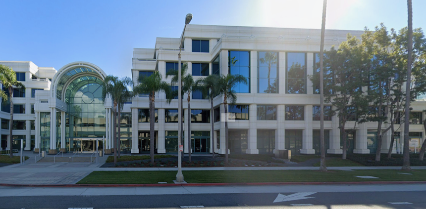 A large building with palm trees in front of it