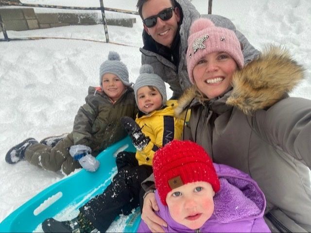 A family is taking a selfie in the snow