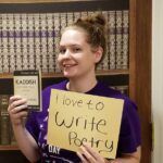 Woman holds book & sign: 