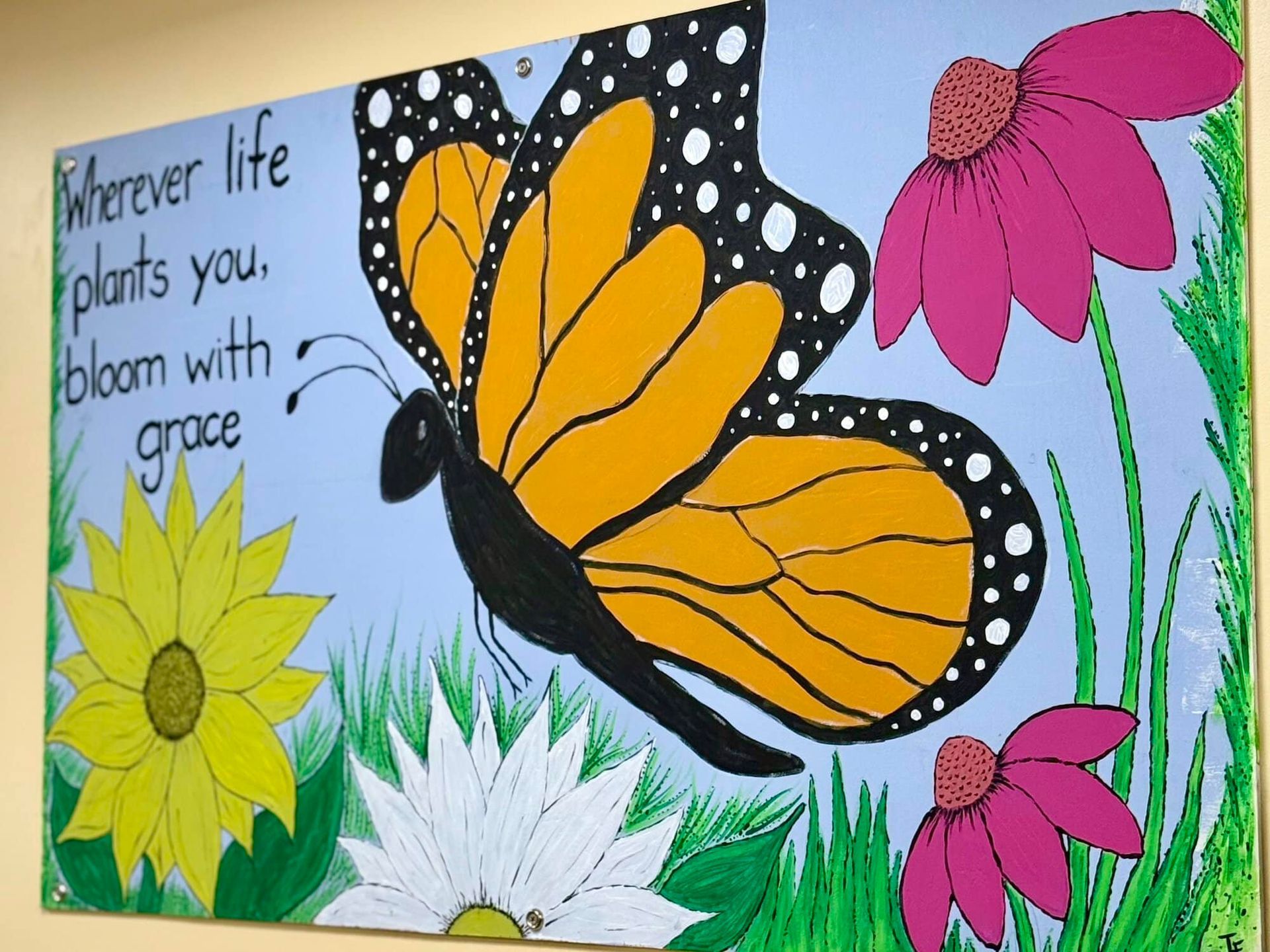 Painting of monarch butterfly, flowers, and grass with text 