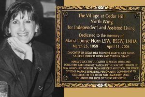 Black and white photo of Maria Louise Horn next to a plaque dedicated to her memory.
