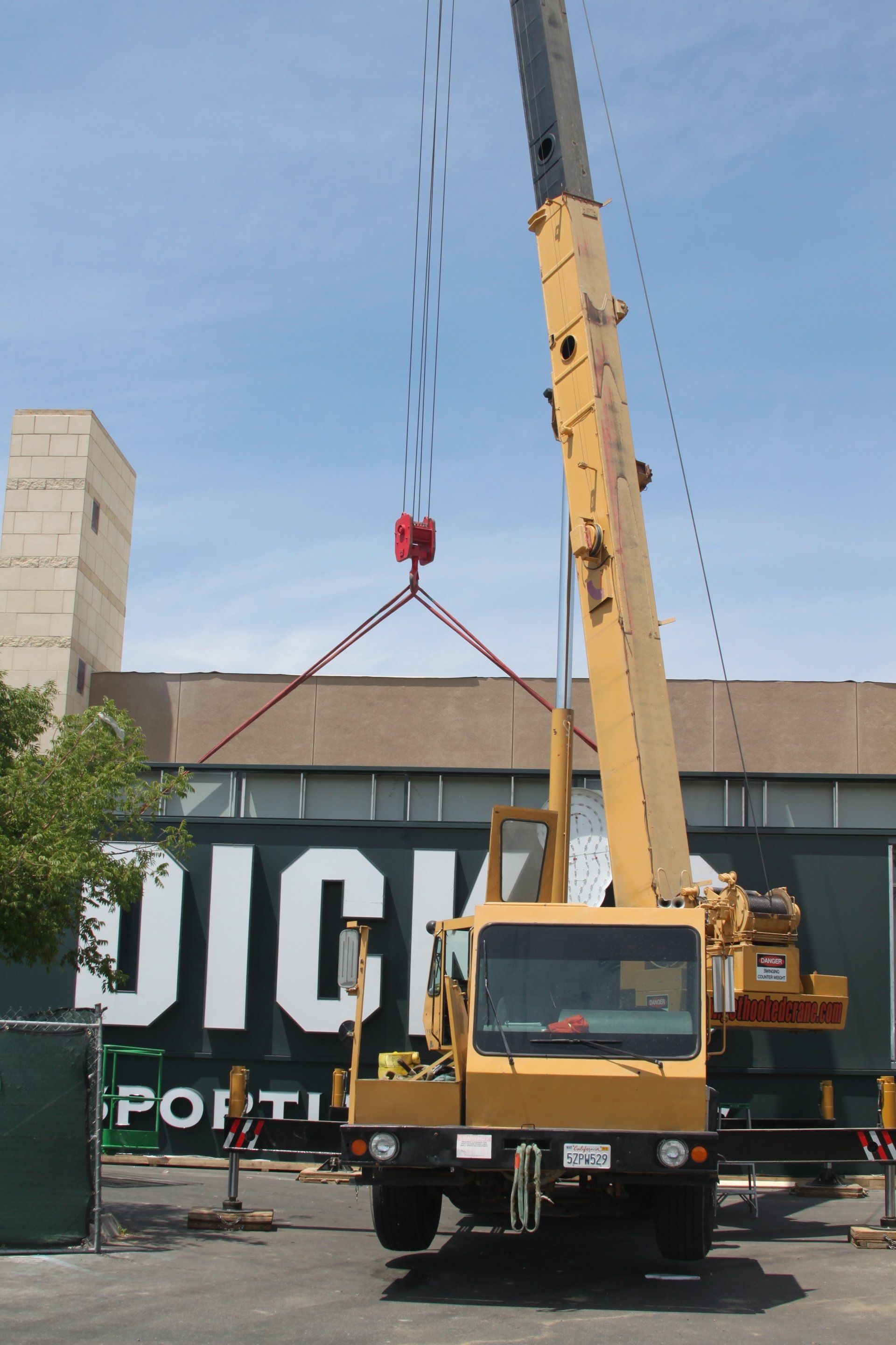 Crane Carrying a Big Sign — Lancaster, CA — Get Hooked Crane Service