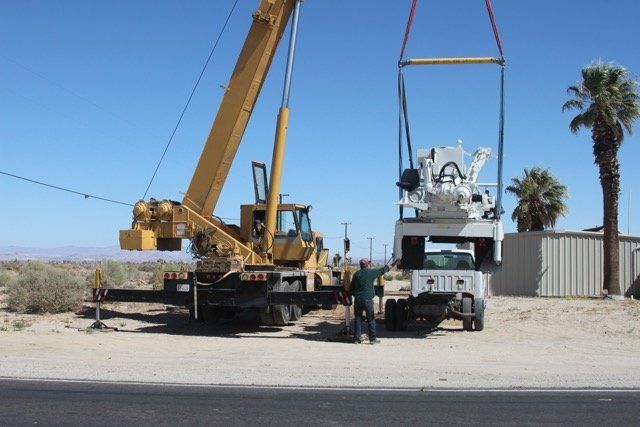 Operator Assisting Crane Carrying a Machine — Lancaster, CA — Get Hooked Crane Service