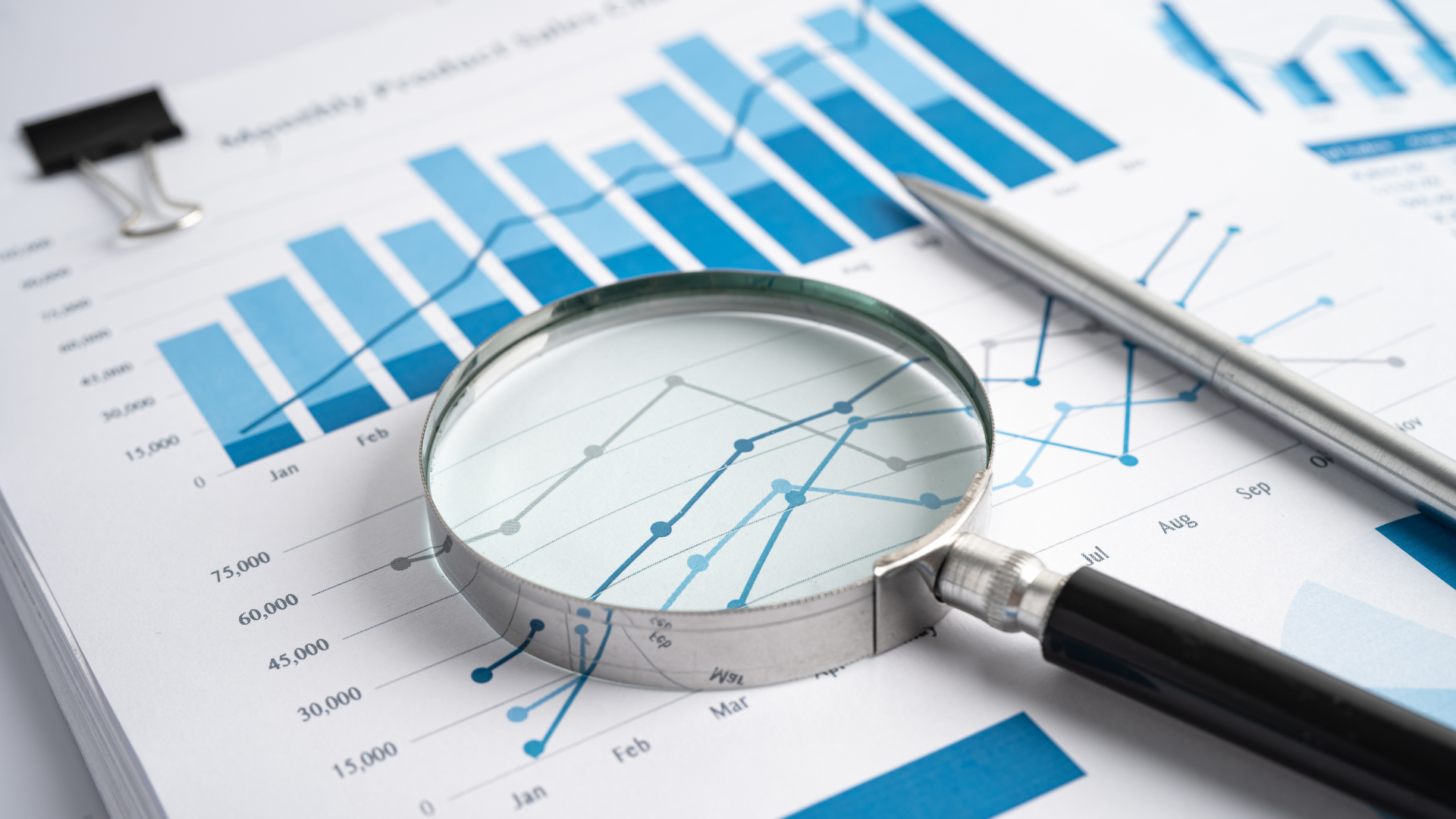 A magnifying glass is sitting on top of a graph.