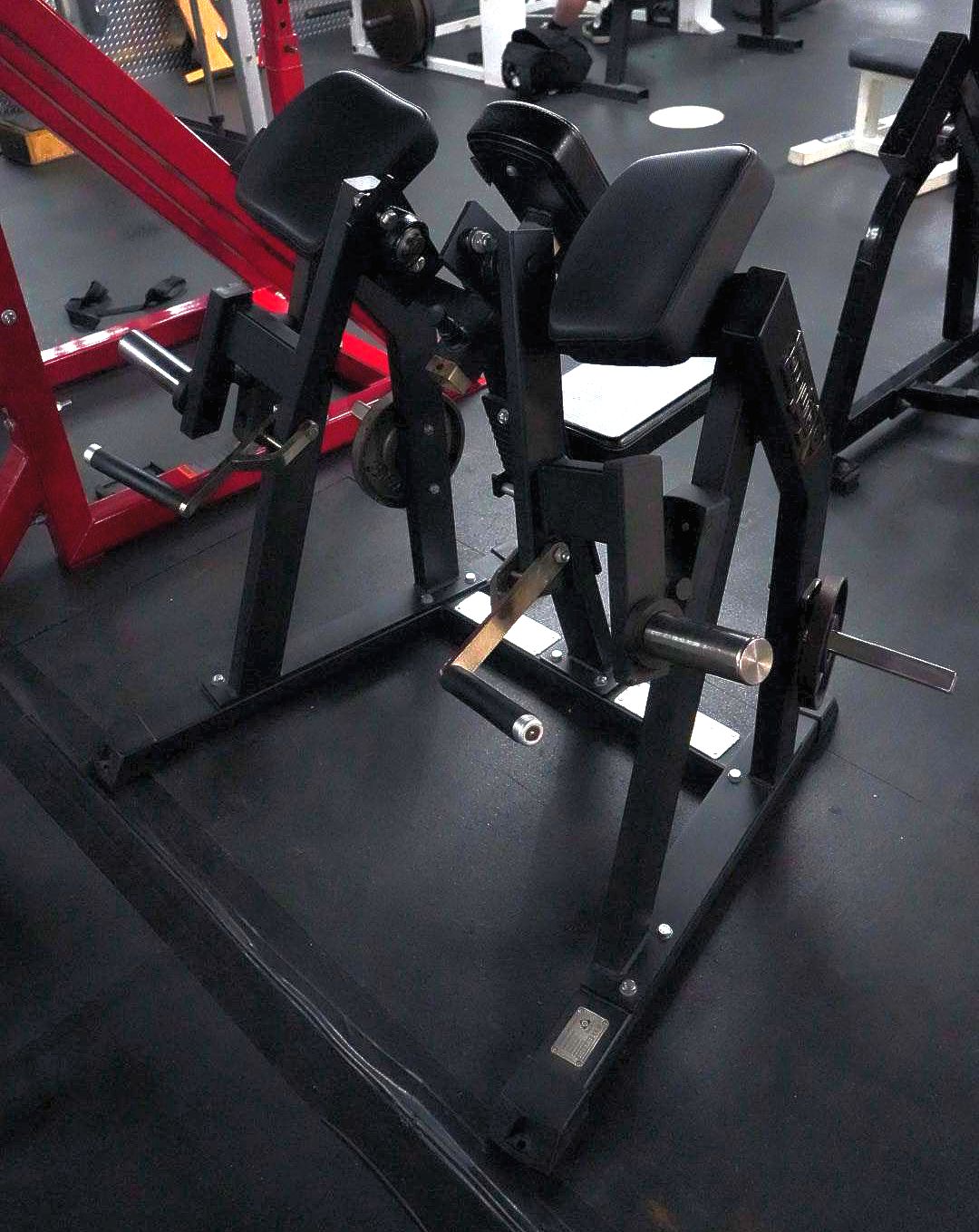 A gym filled with lots of equipment including a machine that says ' matrix ' on it