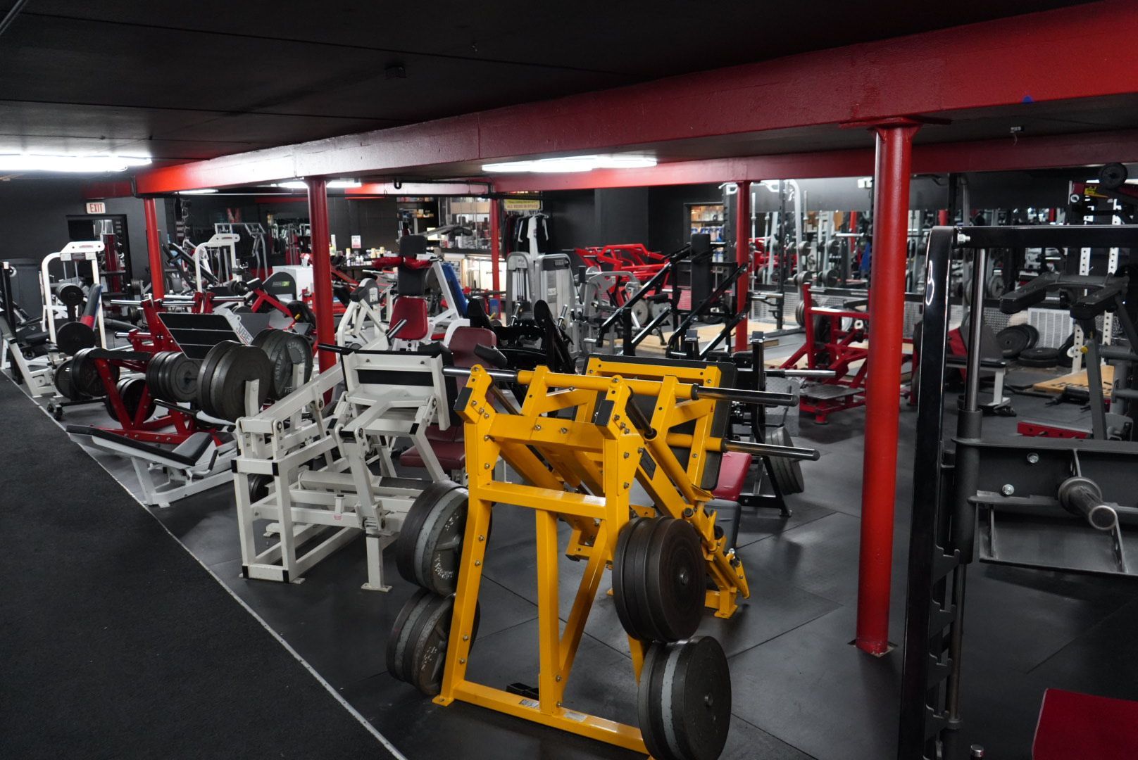 Leg workout machines at Prodigy Gym, including leg presses and extensions, designed for strength and muscle development.
