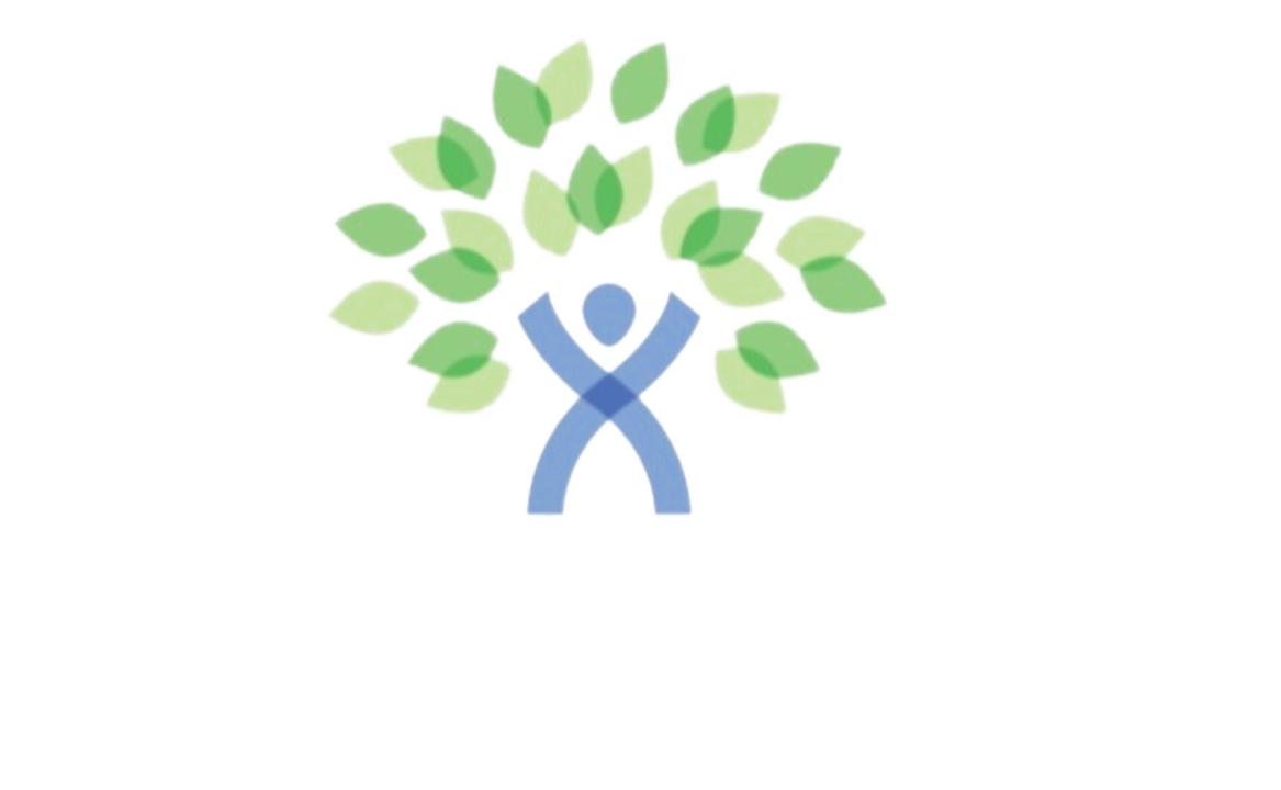 A person is standing in front of a tree with green leaves.