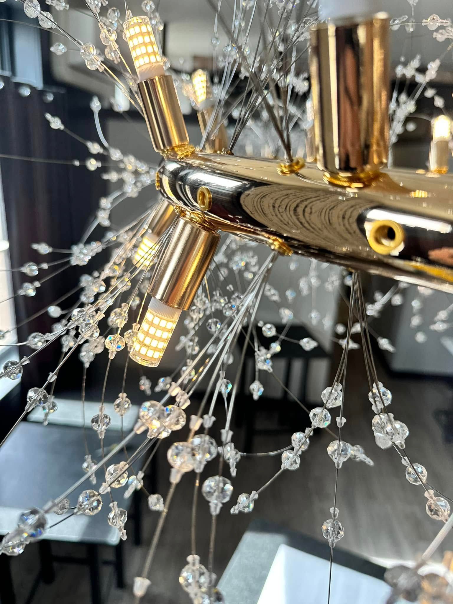 A close up of a chandelier hanging from the ceiling in a room.