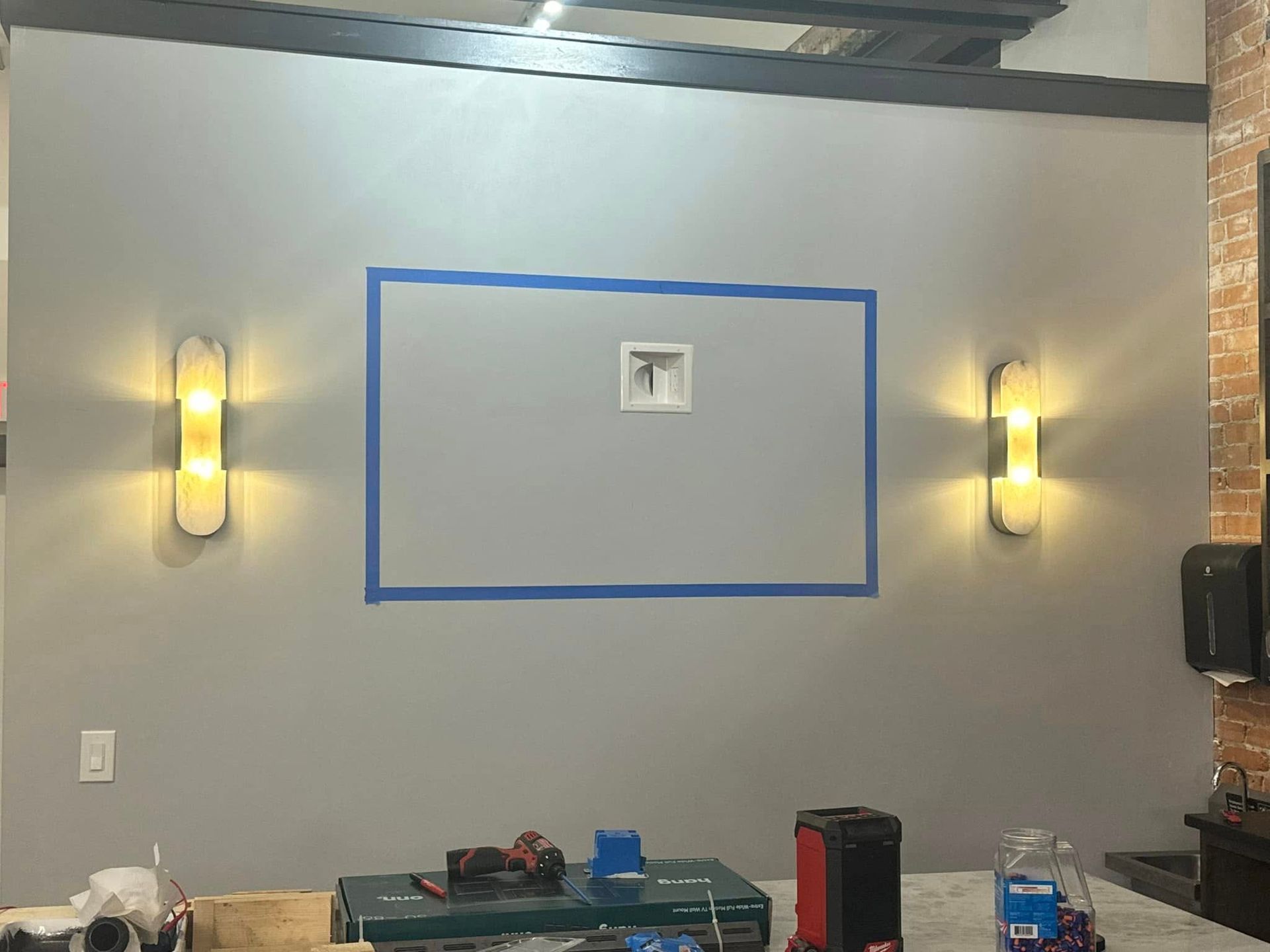 A picture frame is taped to a wall in a room.