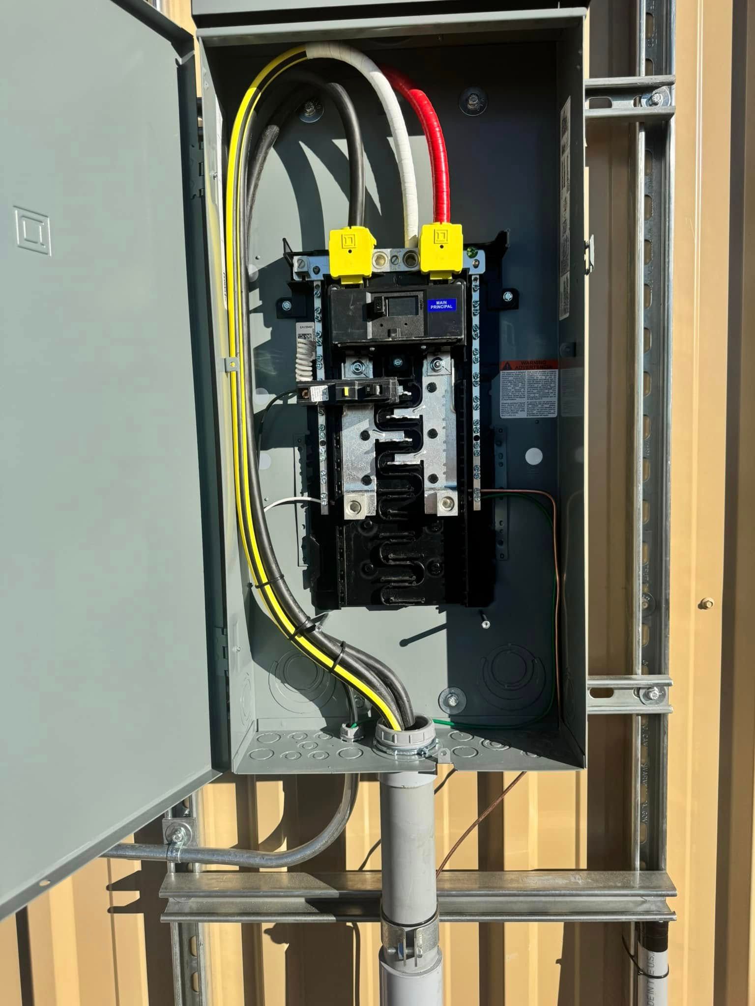 A electrical box with a lot of wires coming out of it.