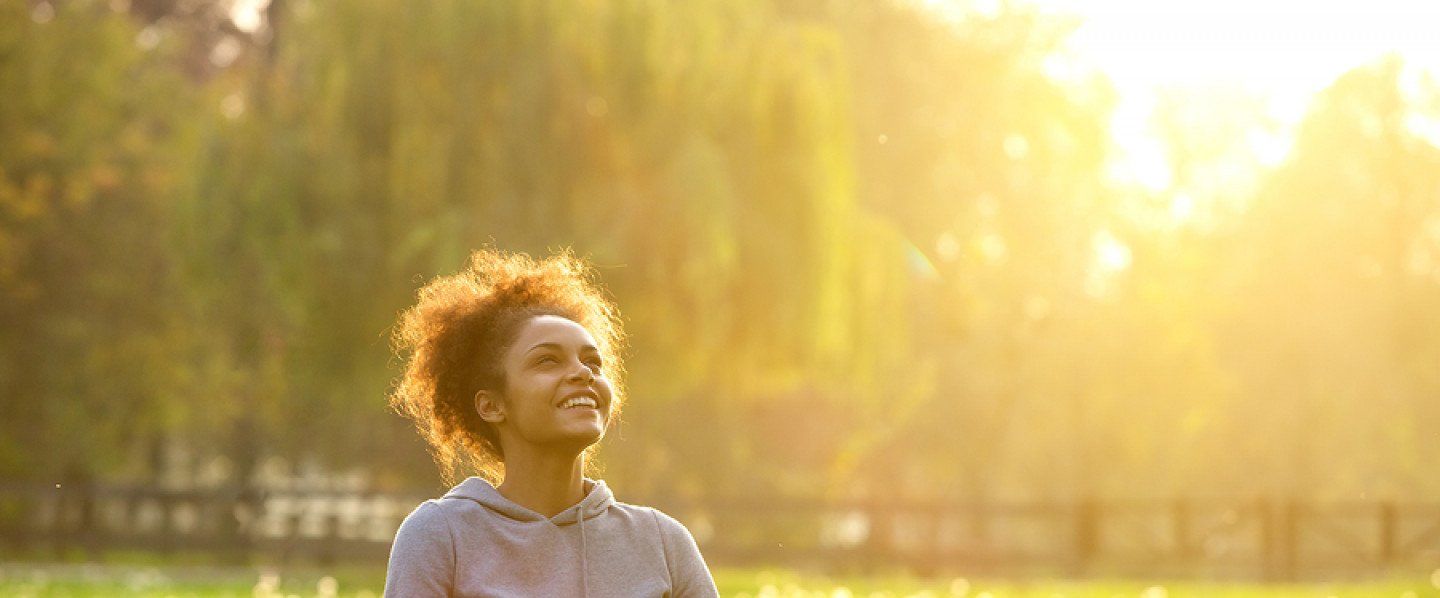 Woman Meditating in Park