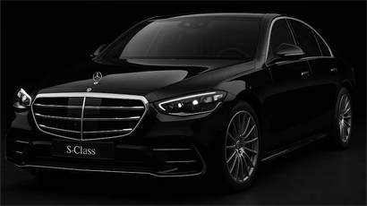 Black Mercedes-Benz S-Class sedan, front view, shiny in the dark.