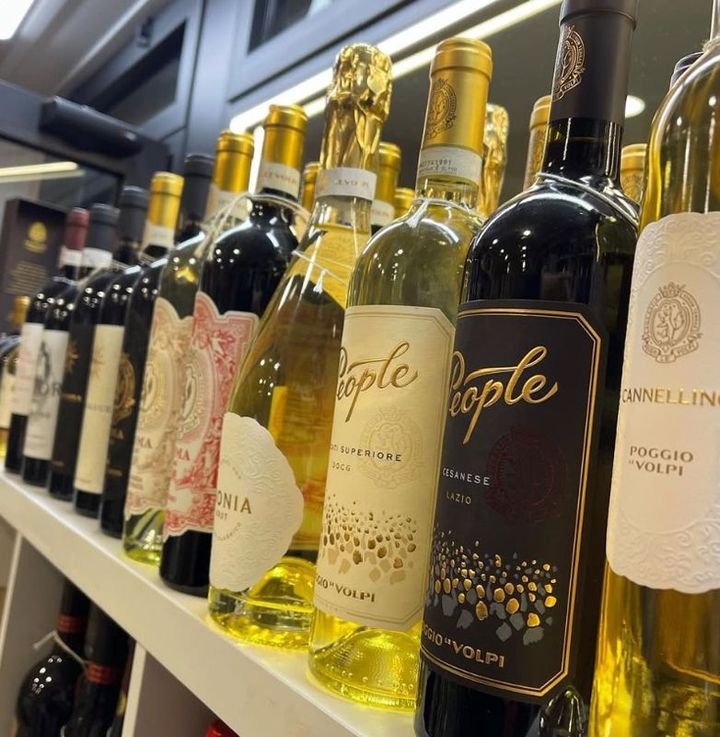 A row of wine bottles including one that says people