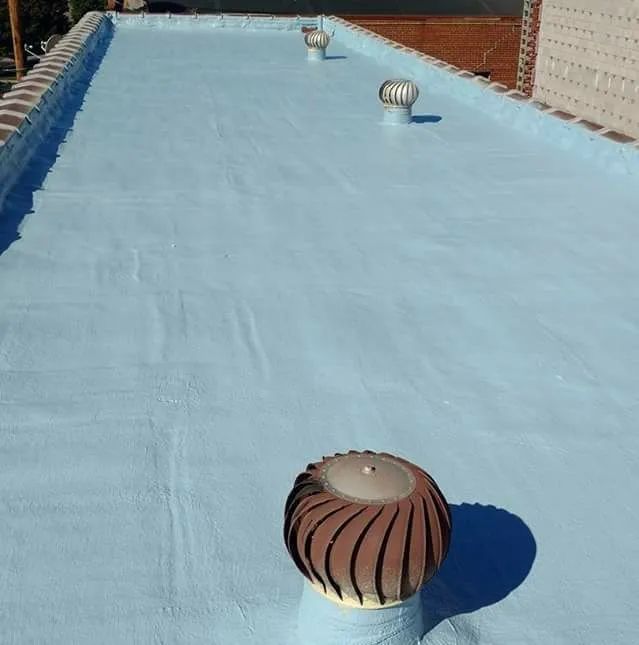 A roof with a wind turbine on top of it